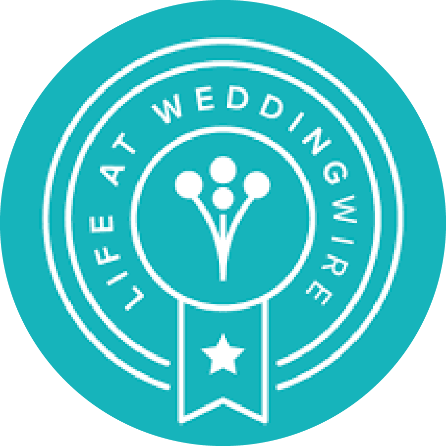 A turquoise circular badge logo for Wedding Wire featuring a white floral bouquet icon in the center, surrounded by concentric rings with text, and a white ribbon banner with a star at the bottom.
