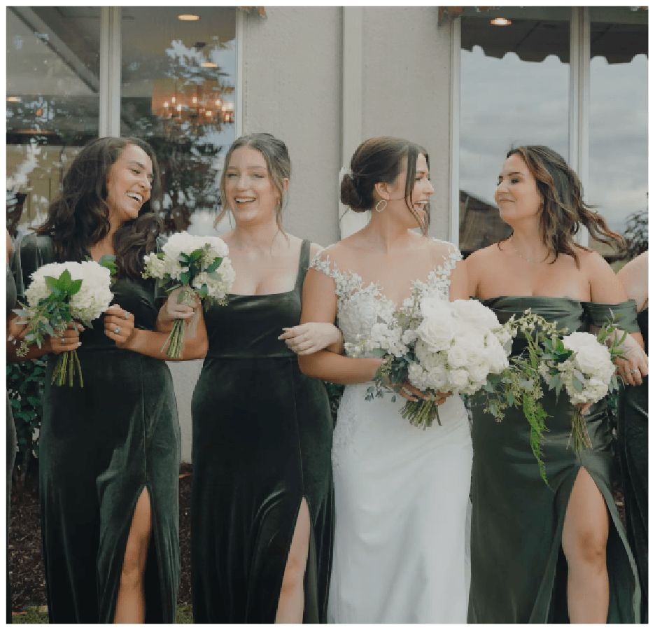 Bride with bridesmaids in dark green dresses holding white bouquets