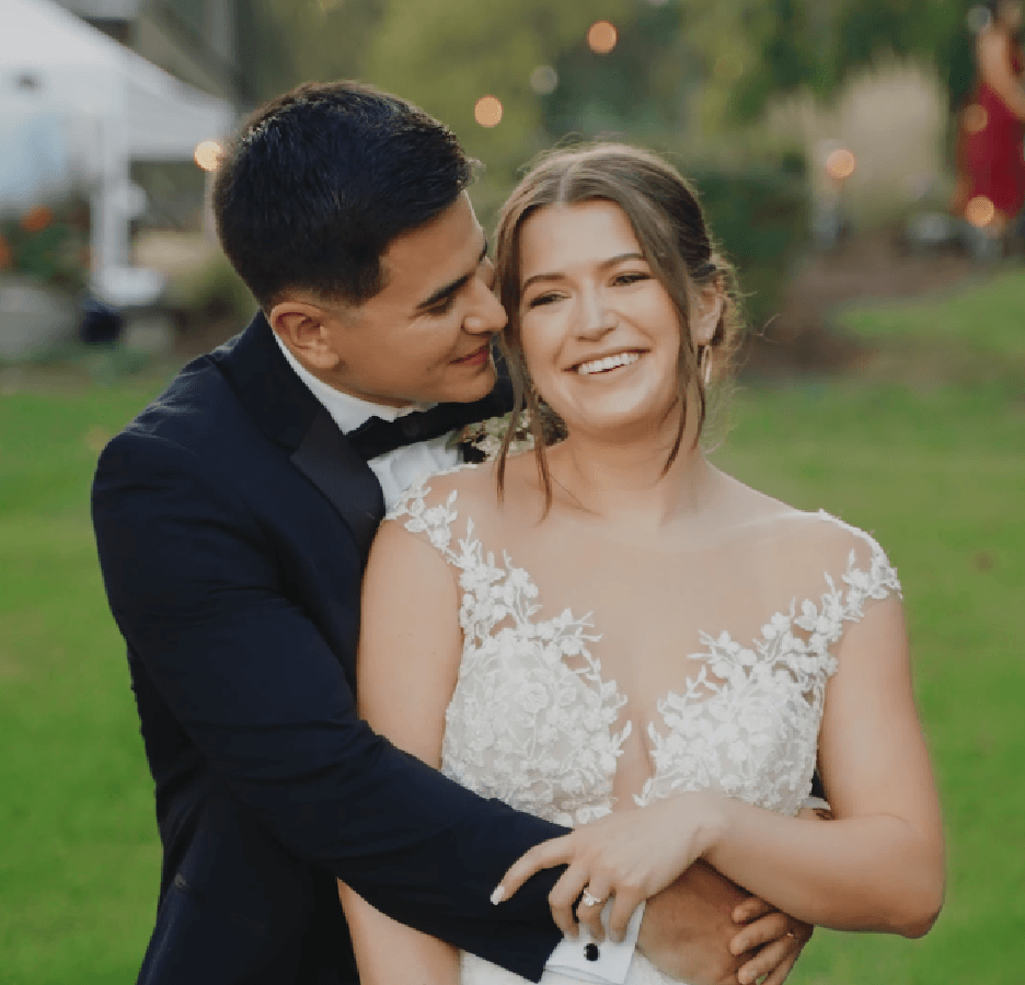 Bride and groom smiling together outdoors during golden hour