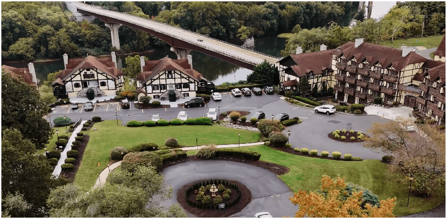 Aerial view of a formal garden wedding venue with a circular fountain and historic buildings
