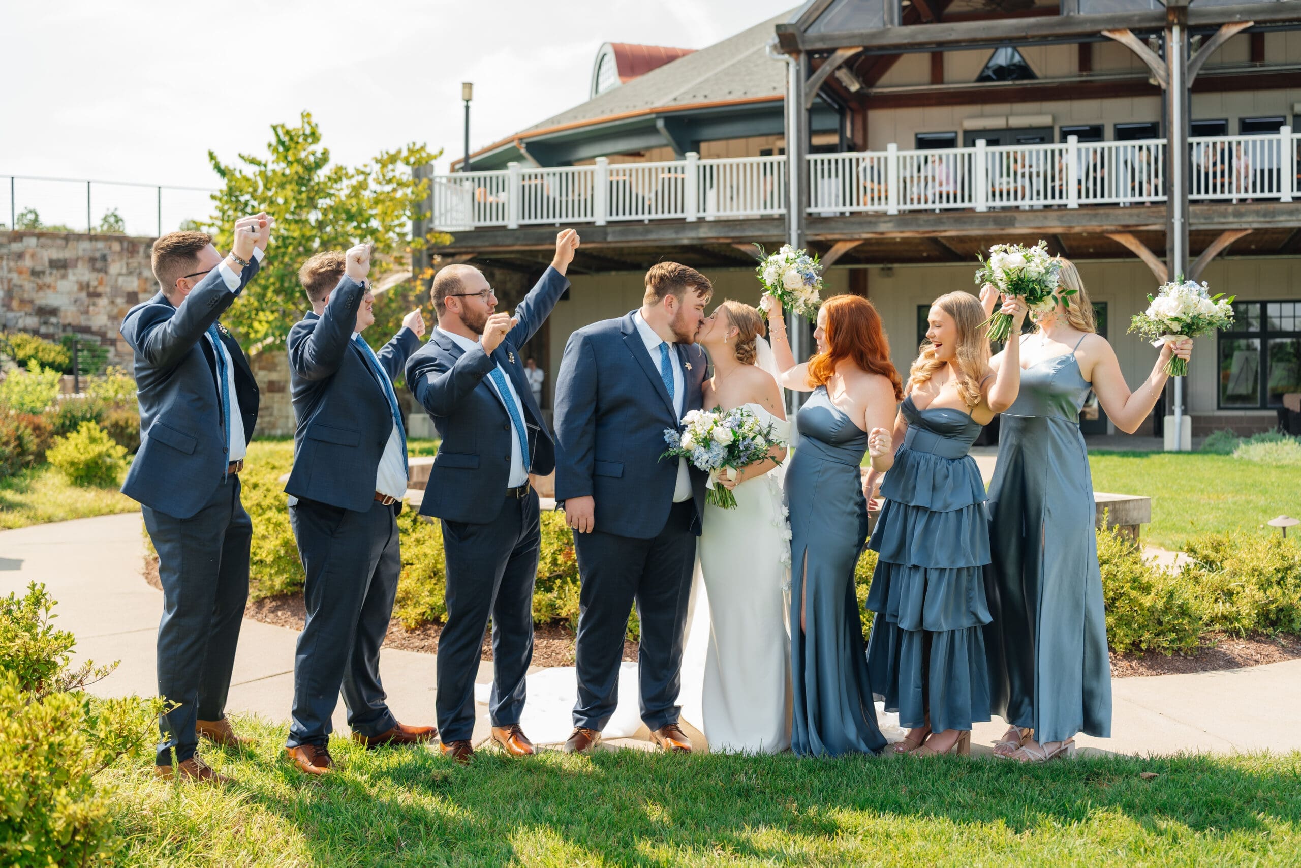 Wedding party standing together in a garden celebration