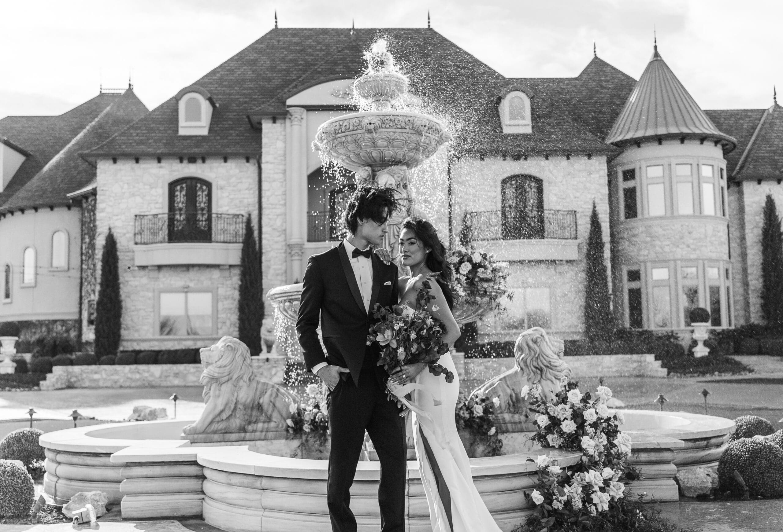 Bride and groom at the altar in front of a floral arch